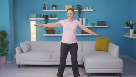 Woman-exercising-at-home-stretching-her-arms.-Healthy-life-fitness.